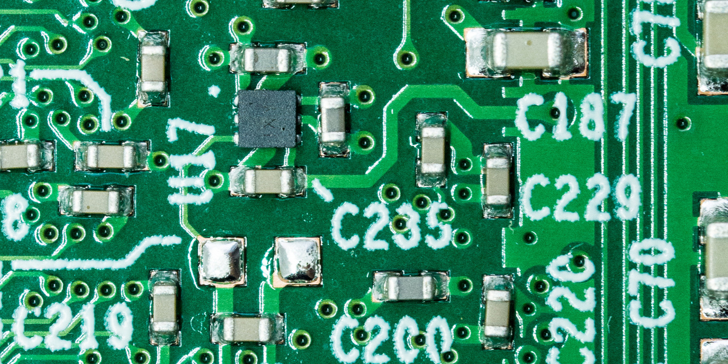 a green printed circuit board from above, the solder joints can be seen