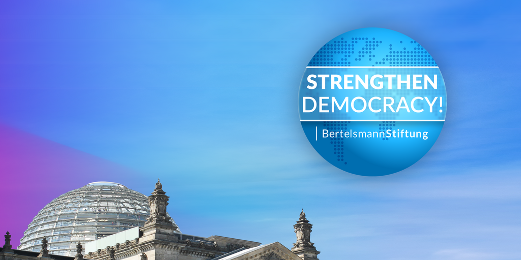 The dome of the Reichstag building in Berlin, with the logo "Strengthen Democracy!" next to it, symbolizing the Bertelsmann Stiftung's annual topic for 2024.