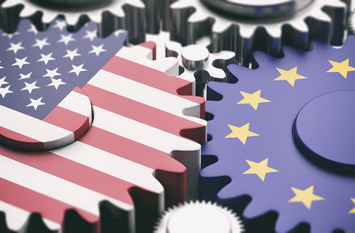 European Union and US of America flags on metal cogwheels