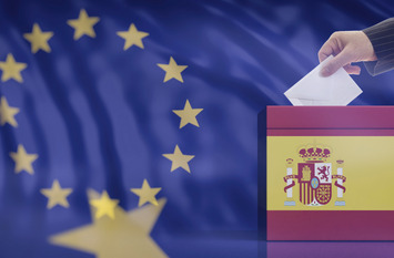 Elections in Spain for EU parliament. Hand inserting an envelope in a Spanish flag ballot box on European Union flag background